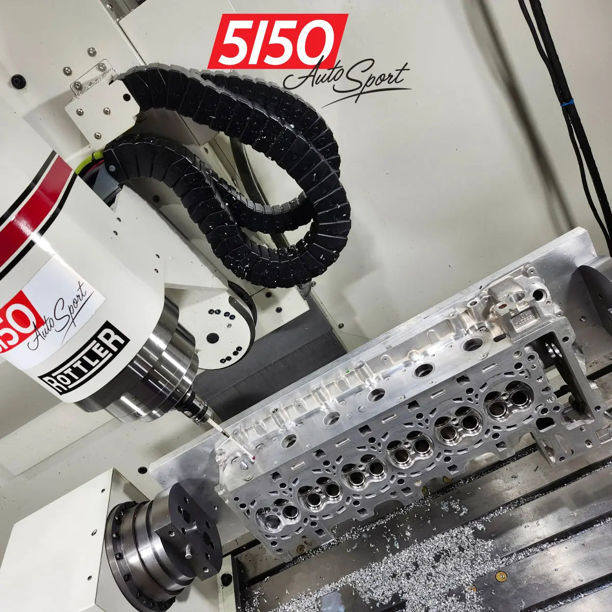 CNC machine working on a BMW N55 motorsport cylinder head for performance modifications