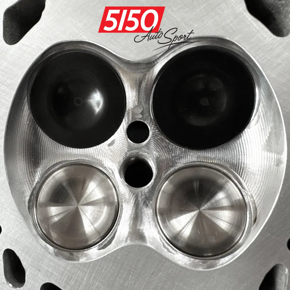 Detailed photo of BMW N55 performance cylinder head showing CNC machined combustion chamber with SuperTech valves installed